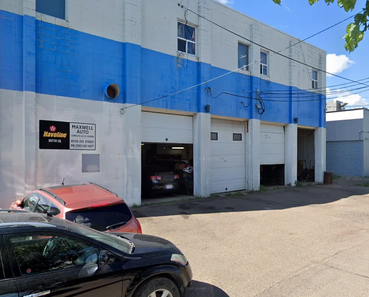 Side of Maxwell Auto Service showing its three service bays under the blue band of the building